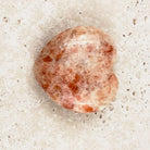Sunstone crystal heart 5cm, peachy cream with bright orange flecks, viewed from above — Eternal Spirit