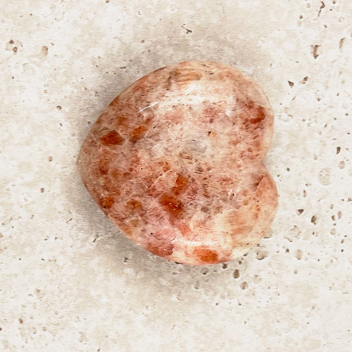 Sunstone crystal heart 5cm, peachy cream with bright orange flecks, viewed from above — Eternal Spirit