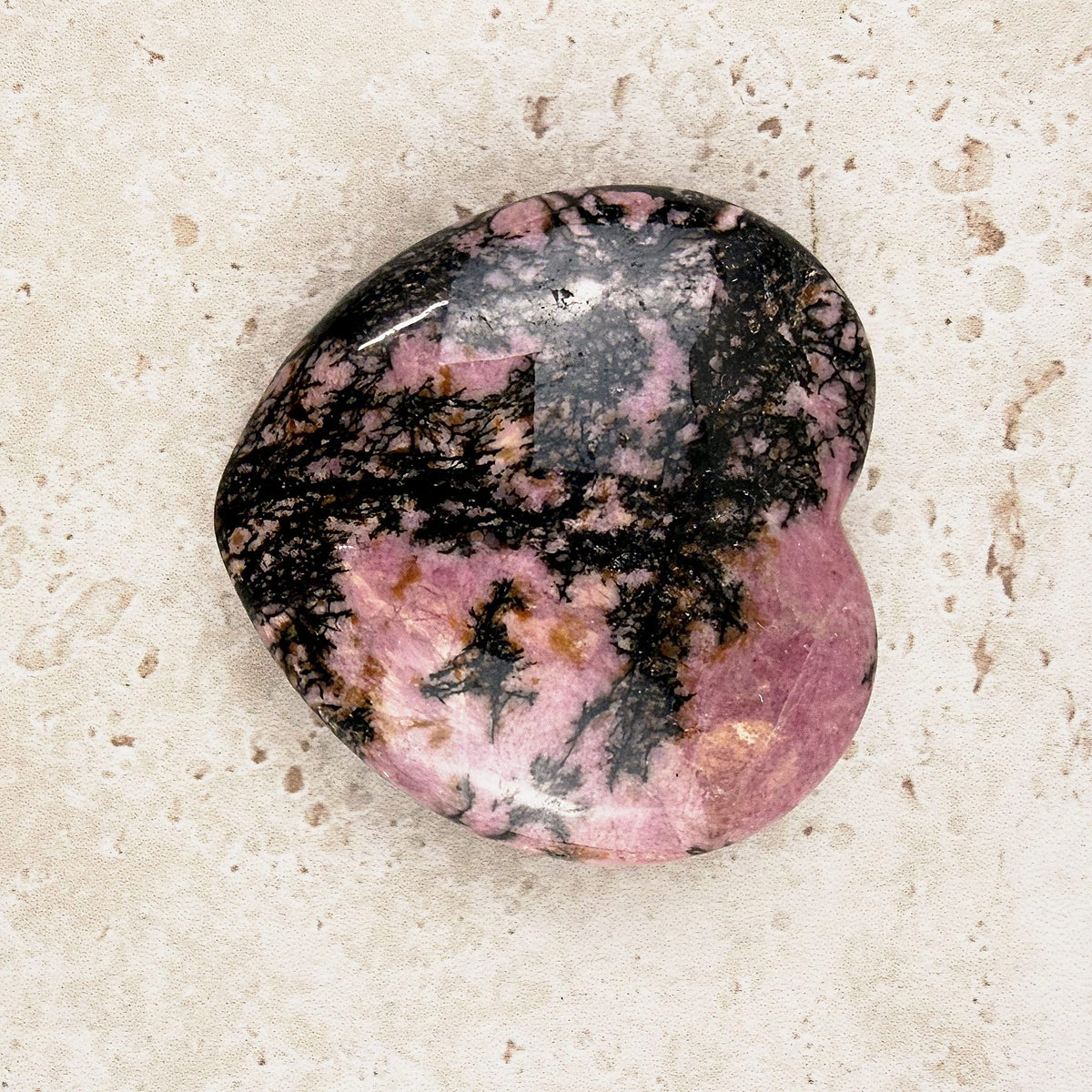 Veined rhodonite crystal heart 5cm, rose pink with branching black veins, viewed from above — Eternal Spirit