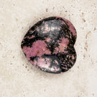 Veined rhodonite crystal heart 5cm, pink and black pattern on a polished face, angled view — Eternal Spirit