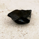 Wedge elite shungite rough crystal 5cm, one smooth gleaming face, side view — Eternal Spirit
