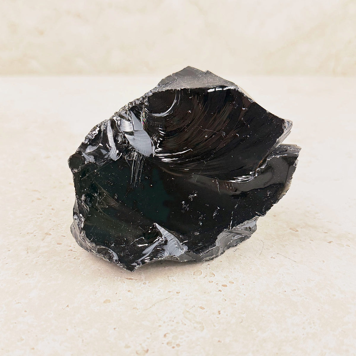 Wide black obsidian rough 10cm, curved shell-like breaks with a mirror shine, front view — Eternal Spirit