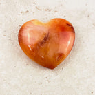 Wide carnelian crystal heart 6.5cm, translucent orange with soft banding, angled view — Eternal Spirit